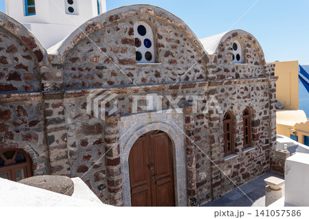 Stone facade of traditional orthodox church in Oia Santorini Stone facade of traditional orthodox church in Oia Santorini 141057586