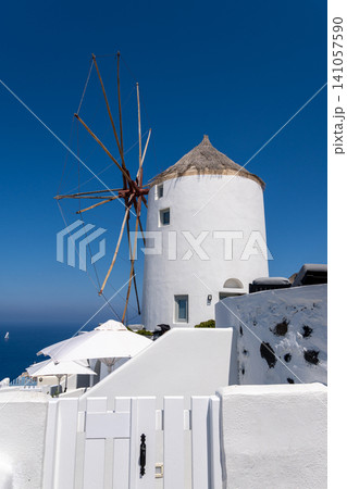 Traditional white windmill under clear blue sky in Oia Santorini Traditional white windmill under clear blue sky in Oia Santorini 141057590