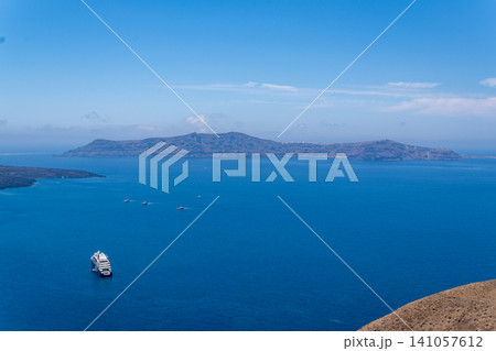 Cruise ship near Thirasia island in Santorini volcanic caldera Cruise ship near Thirasia island in Santorini volcanic caldera 141057612