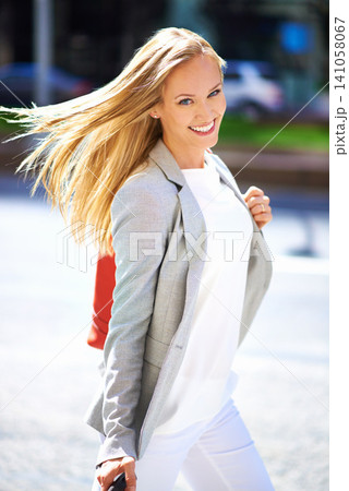 Smile, urban and businesswoman in city, luggage and travel to workplace or seminar. Portrait, confidence and happiness for business consultant in New York, freelance or commute to work or meeting 141058067