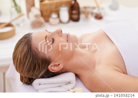 Woman, face and top view with eyes closed at spa, massage and wellness with calm for zen and self care. Cosmetics, beauty and holistic healing, relax and peace at luxury resort with treatment Woman, face and top view with eyes closed at spa, massage and wellness with calm for zen and self care. Cosmetics, beauty and holistic healing, relax and peace at luxury resort with treatment 141058214