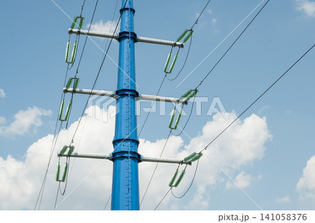 High voltage power line tower against blue sky High voltage power line tower against blue sky 141058376