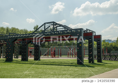 Outdoor obstacle course fitness structure in park 141058390