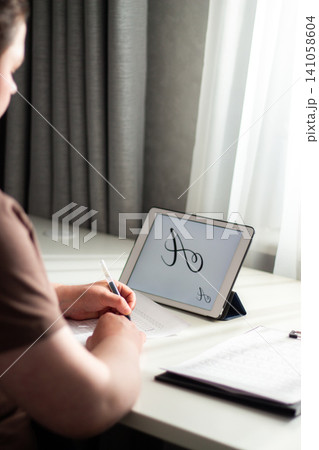 Close up of woman hand training handwriting. Activation of unique cognitive and motor circuits, enhancing memory retention, focus and deep concentration concept Close up of woman hand training handwriting. Activation of unique cognitive and motor circuits, enhancing memory retention, focus and deep concentration concept 141058604