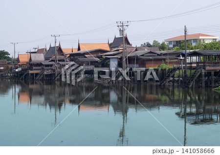 Traditional Thai Houses on Stilts Column Over a Peaceful River in a Rural near Bangkok 141058666