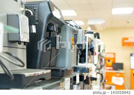 A Versatile Display of Modern Espresso Machines Showcasing Various Designs and Features in a Home Appliance Retail Environment A Versatile Display of Modern Espresso Machines Showcasing Various Designs and Features in a Home Appliance Retail Environment 141058942