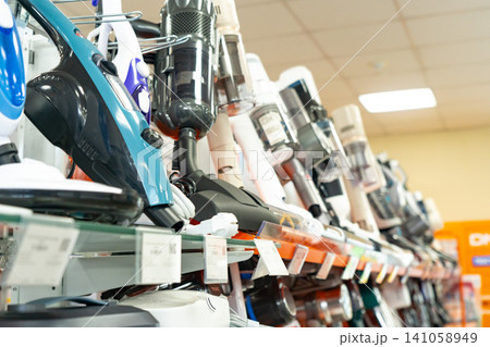 Variety of Modern Vacuum Cleaners Displayed on Retail Shelves, Showcasing Diverse Designs and Technologies for Efficient Home Cleaning Variety of Modern Vacuum Cleaners Displayed on Retail Shelves, Showcasing Diverse Designs and Technologies for Efficient Home Cleaning 141058949