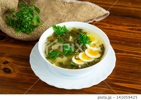Traditional sorrel borscht with boiled eggs and parsley Traditional sorrel borscht with boiled eggs and parsley 141059425