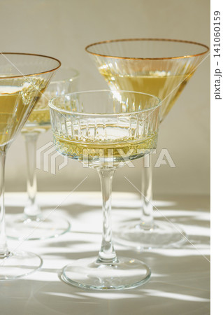 Elegant glasses receiving sunlight and creating shadows 141060159