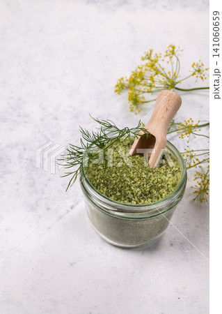 Dill herb salt in glass jar with scoop Dill herb salt in glass jar with scoop 141060659