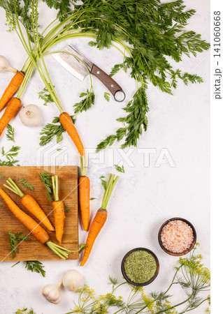 Carrots, garlic, spices, and cleaver on white background Carrots, garlic, spices, and cleaver on white background 141060668
