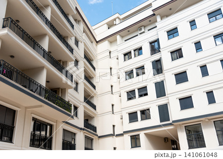 Multi storey residential building suburb city, house background sunny summer day Multi storey residential building suburb city, house background sunny summer day 141061048
