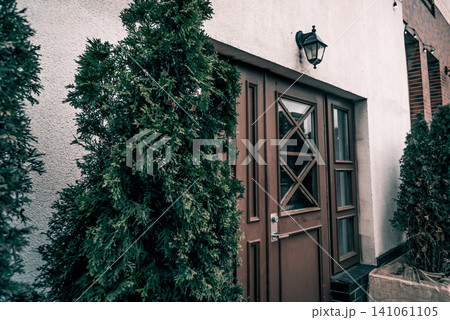 Entrance door small residential house in neighborhood, exterior building outside 141061105