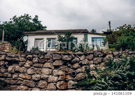 Small residential house cottage in suburbs neighborhood country exterior outside Small residential house cottage in suburbs neighborhood country exterior outside 141061109