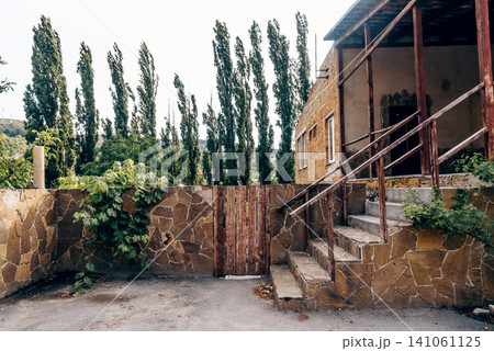 Entrance door small residential house in neighborhood, exterior building outside Entrance door small residential house in neighborhood, exterior building outside 141061125