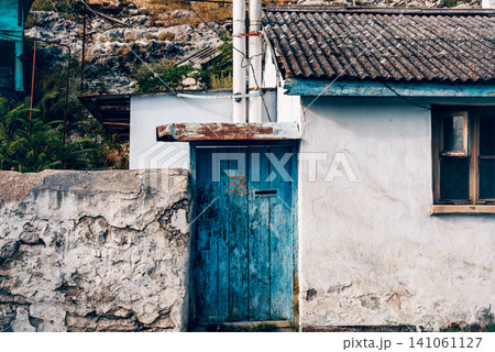 Entrance door small residential house in neighborhood, exterior building outside Entrance door small residential house in neighborhood, exterior building outside 141061127