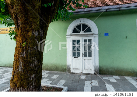 Entrance door small residential house in neighborhood, exterior building outside 141061181