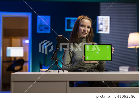 Isolated mockup on tablet with young influencer filming a vlog at home, smiling and talking into camera. Gen Z girl creating lifestyle content for social media audience, entertainment culture. Isolated mockup on tablet with young influencer filming a vlog at home, smiling and talking into camera. Gen Z girl creating lifestyle content for social media audience, entertainment culture. 141062386