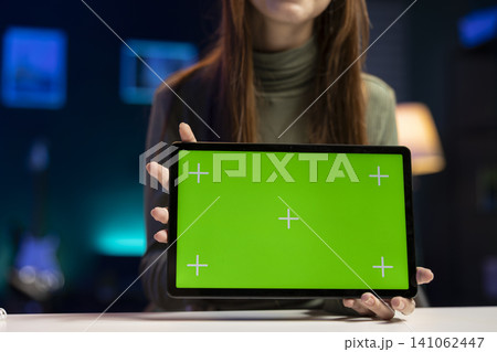 Isolated mockup on tablet with young influencer filming a vlog at home, smiling and talking into camera. Gen Z girl creating lifestyle content for social media audience, entertainment culture. Isolated mockup on tablet with young influencer filming a vlog at home, smiling and talking into camera. Gen Z girl creating lifestyle content for social media audience, entertainment culture. 141062447