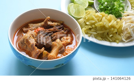 rice vermicelli with northern thai curry sauce on blue background rice vermicelli with northern thai curry sauce on blue background 141064126
