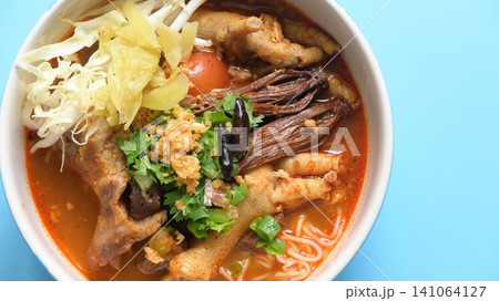 rice vermicelli with northern thai curry sauce on blue background rice vermicelli with northern thai curry sauce on blue background 141064127