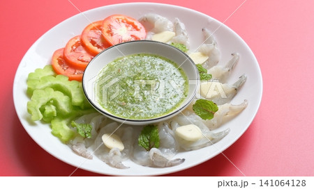 shrimp in fish sauce with Thai spicy seafood dipping sauce on white plate shrimp in fish sauce with Thai spicy seafood dipping sauce on white plate 141064128