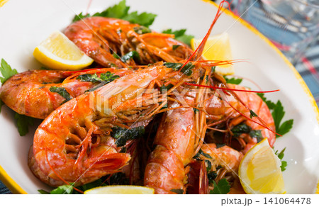 Grilled shrimps with lemon and parsley Grilled shrimps with lemon and parsley 141064478
