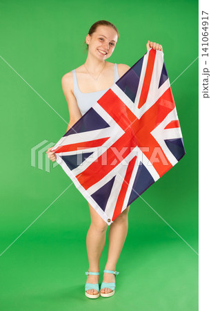 Teenage girl holding UK flag in front of green screen Teenage girl holding UK flag in front of green screen 141064917