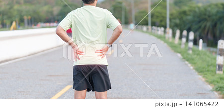 Adult male runner with back and waist ache due to piriformis syndrome and low back pain. man having muscle injury or spinal compression during running. Sports medicine and healthcare concept Adult male runner with back and waist ache due to piriformis syndrome and low back pain. man having muscle injury or spinal compression during running. Sports medicine and healthcare concept 141065422