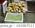 Fresh green sugarcane stalks and chopped pieces on market stall 141067511