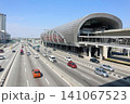 Modern airport terminal with busy highway and cars outside 141067523