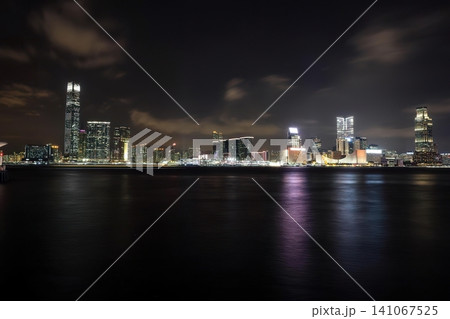 Night city skyline with tall buildings and bright lights Night city skyline with tall buildings and bright lights 141067525