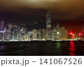 Night city skyline with tall buildings and reflections on water 141067526