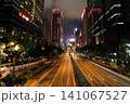 Night city street with tall buildings and city lights 141067527