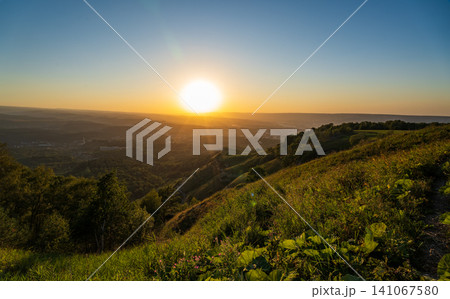 View of the mountains and Kislovodsk from the observation decks of the Kislovodsk Park. Evening sunset over the mountains of Kislovodsk. View of the mountains and Kislovodsk from the observation decks of the Kislovodsk Park. Evening sunset over the mountains of Kislovodsk. 141067580