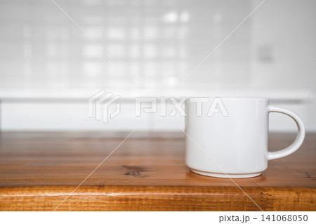 Close up of white coffee mug on wooden table right side Close up of white coffee mug on wooden table right side 141068050