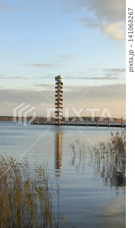 A spiral tower over the water at sunset 141068267