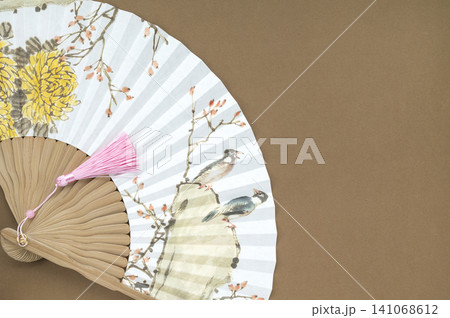 A fan featuring a traditional Korean painting and Copy Space A fan featuring a traditional Korean painting and Copy Space 141068612