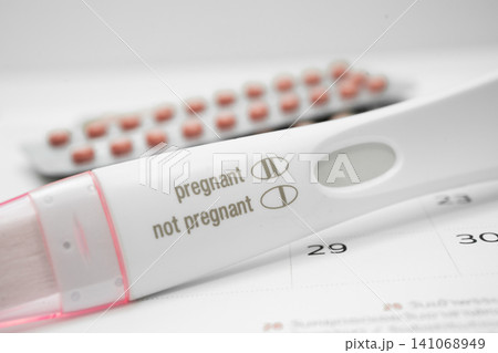 Pregnancy test on calendar, contraception health and medicine. Pregnancy test on calendar, contraception health and medicine. 141068949