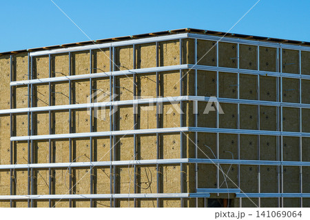 Modern Building Facade with Mineral Wool Insulation and Metal Framing Before Exterior Cladding Install Modern Building Facade with Mineral Wool Insulation and Metal Framing Before Exterior Cladding Install 141069064