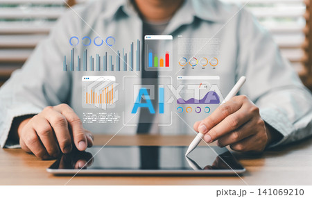 Businessperson using tablet and stylus to analyze financial data charts with AI holographic interface. Futuristic artificial intelligence tech for business analytics and marketing growth Businessperson using tablet and stylus to analyze financial data charts with AI holographic interface. Futuristic artificial intelligence tech for business analytics and marketing growth 141069210