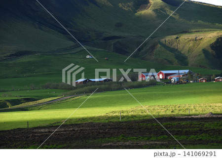 Traditional red farm houses in the green mountain valley of Iceland Traditional red farm houses in the green mountain valley of Iceland 141069291