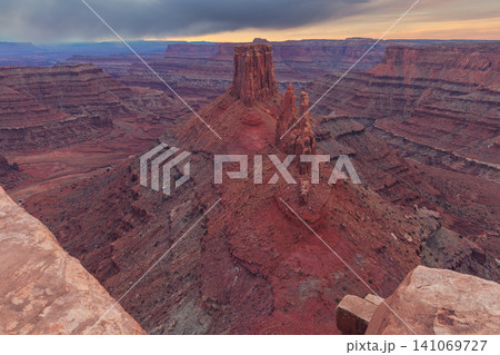 Majestic red rock canyon landscape in utah offering an awe inspiring and peaceful view over vast desert valley beneath dramatic sky during beautiful sunset 141069727