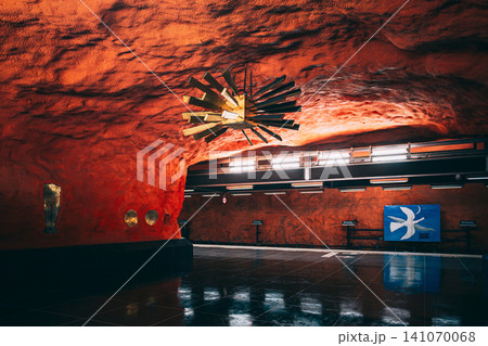 Orange rock cave tunnel with golden ornament at Ostermalmstorg metro station Orange rock cave tunnel with golden ornament at Ostermalmstorg metro station 141070068