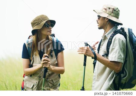 Couple hiking with backpacks near lake. Outdoor adventure and travel lifestyle. Couple hiking with backpacks near lake. Outdoor adventure and travel lifestyle. 141070660