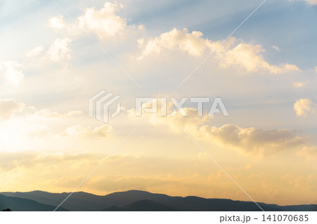 Peaceful sky with soft clouds over mountain landscape. Concept of hope, calmness and natural background. 141070685