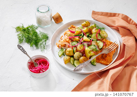 Baked salmon fillet, new potatoes, pickled onion Baked salmon fillet, new potatoes, pickled onion 141070767