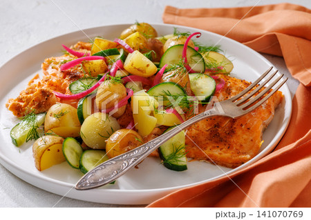 Baked salmon fillet, new potatoes, pickled onion Baked salmon fillet, new potatoes, pickled onion 141070769
