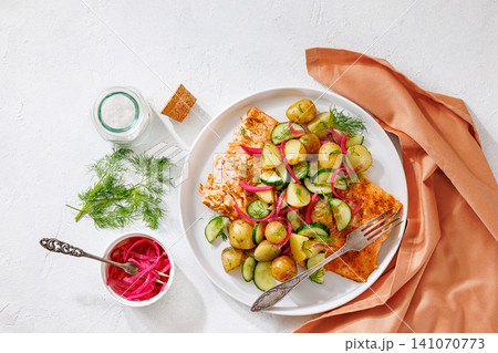 Baked salmon fillet, new potatoes, pickled onion Baked salmon fillet, new potatoes, pickled onion 141070773