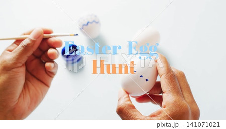 Image of easter egg hunt text over woman painting easter eggs on white background 141071021